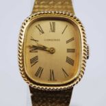 A 9ct yellow gold lady's Longines manual wind wristwatch, having a cushion shaped baton dial with