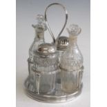 A George III silver and cut glass cruet set. comprising a circular silver and wooden-based frame