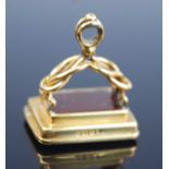 An 18ct yellow gold fob seal, having a carnelian intaglio engraved with interwoven initials, with