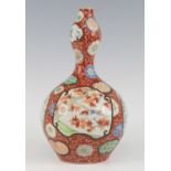 A Japanese Imari porcelain vase, Meiji period, the garlic neck above a gobular body, enamel