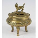 A Chinese gilt bronze tripod censer and cover, the pierced cover surmounted with a Fo Dog, the