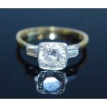 A yellow and white metal diamond solitaire ring, comprising a round brilliant cut diamond in a