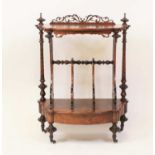 A mid Victorian walnut and figured walnut Canterbury whatnot of shaped outline with concealed base