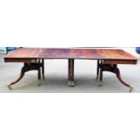A Regency mahogany twin pedestal dining table, the top having two extra leaves, each with a reeded