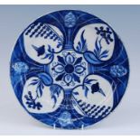A Delft blue and white charger, 18th century, decorated with alternating heart motifs, possibly