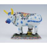 A Delft polychrome model of a cow, probably 19th century, shown in standing pose, decorated with