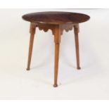 A George III fruitwood topped cricket table, as a circular 5 section plank top, to a fruitwood and