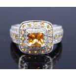 A 14ct white gold, citrine and diamond square cluster ring, featuring a centre square cut citrine