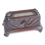 A Victorian mahogany money box, of domed rectangular form, having a central coin aperture flanked by