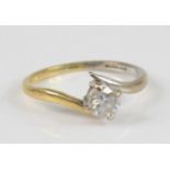 An 18ct yellow and white gold diamond single stone ring, featuring a round brilliant cut diamond