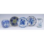 A Delft blue and white dish, 18th century, decorated with flowers, dia.19cm, together with two