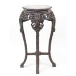 A Chinese carved rosewood jardiniere stand, of octagonal baluster form with marble inset top and