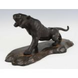 A Japanese bronze tiger, Meiji period, the roaring beast depicted in full stride with glossy stripes