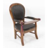 A Victorian child's fruitwood elbow chair, having rexine upholstered pad back and arms, h.60.5cm,