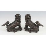 A pair of Chinese carved hardwood Fo dogs, each in seated pose with glass eyes, h.22cm