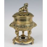 A Chinese gilt bronze censer and cover on stand, the pierced cover surmounted with a Fo Dog, the