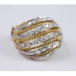 A yellow and white metal diamond bombe cluster ring, comprising 37 single cut diamonds grain set