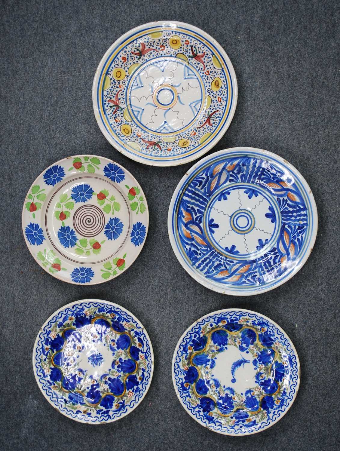 A collection of five Spanish polychrome glazed earthenware dishes, to inlcude Manises examples, 19th