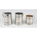 Three silver christening tankards, being a George III example, of cylindrical form with reeded