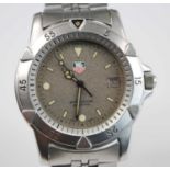 A stainless steel Tag Heuer Professional quartz watch, having round grey baton dial with date at 3