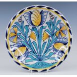 A Delft polychrome charger, 20th century, in the 17th century London style, decorated with tulips,