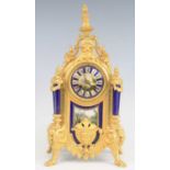 A late 19th century French gilt metal porcelain inset mantel clock (re-gilded), having a convex