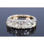 A late Victorian yellow and white metal diamond five-stone half eternity ring, featuring five