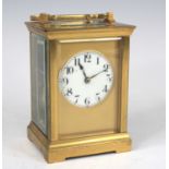 A circa 1900 French brass carriage clock, having an unsigned white enamel Arabic dial (hairline from
