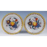 A pair of Dutch polychrome chargers, 18th century, each decorated with fruit within a spearhead