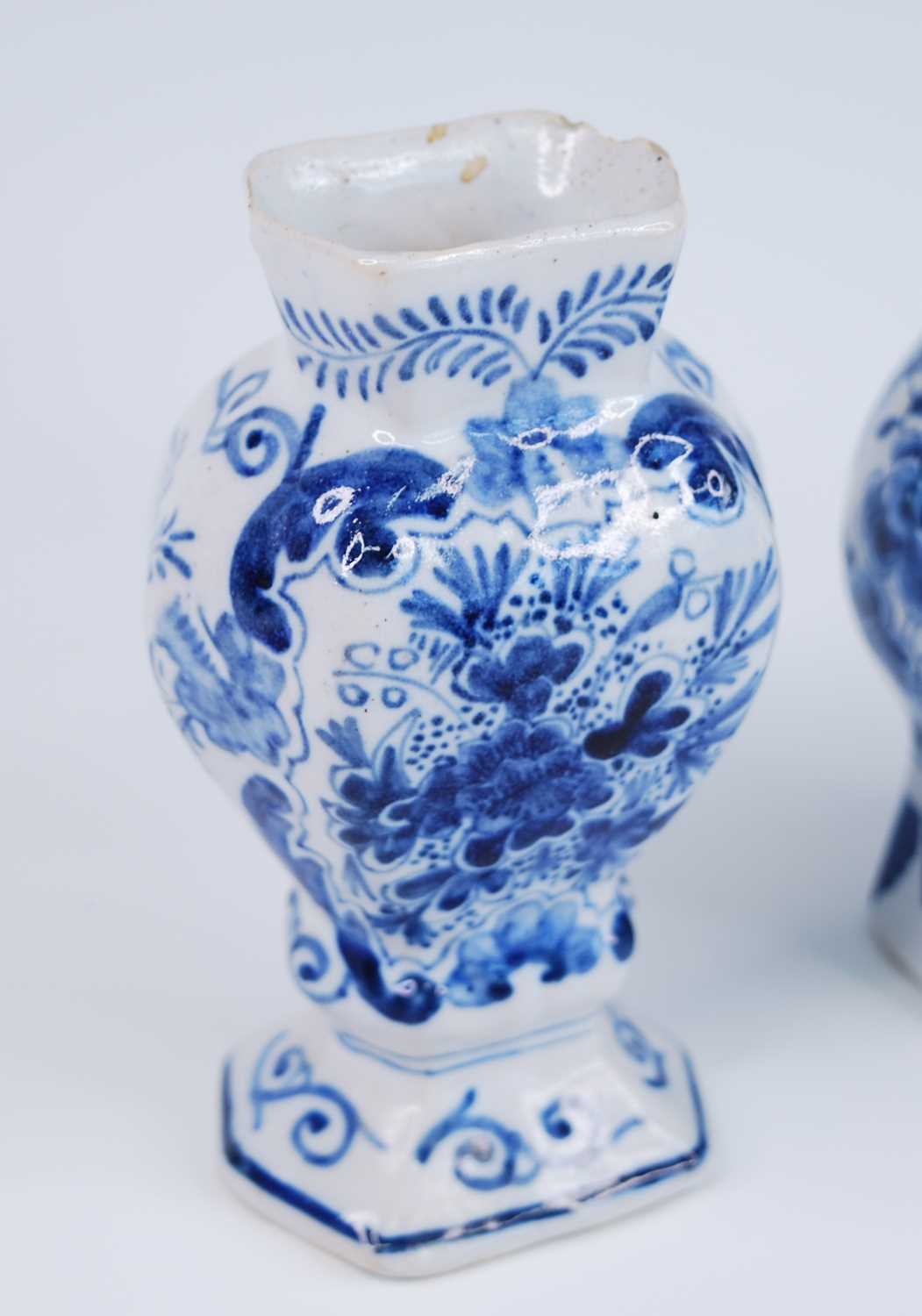 A Delft blue and white vase, 18th century, the garlic neck above a globular body, decorated with - Image 2 of 9
