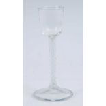 A cordial glass, the ogee bowl above an air and opaque twist stem and slightly domed foot, h.15.5cm