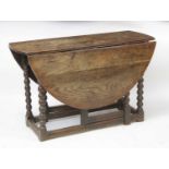 An antique joined oak gateleg table, the probably associated top having oval fall leaves above an