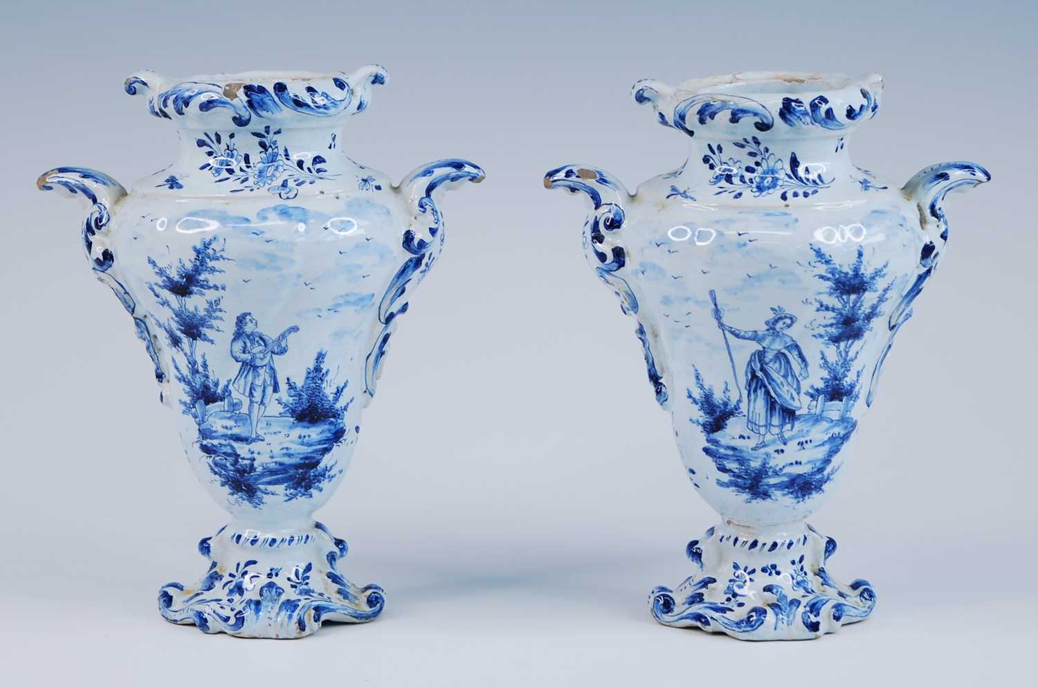 A pair of Delft blue and white vases, late 17th/18th century, each of wrythen form, flanked by C-