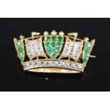 A yellow metal, emerald and diamond coronet brooch, featuring 17 round faceted emeralds