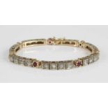 A yellow metal, ruby and diamond set tennis bracelet, arranged as seven four-section links each