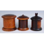 A 19th century lignum vitae string box, of cylinderical form, the domed screw cover with
