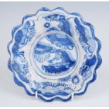 A Delft blue and white dish, late 17th century, of lobed form, the well decorated with a