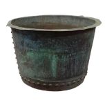 A circa 1900 large copper log bucket of circular form with riveted construction, verdigris patina,