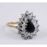 An 18ct yellow and white gold, sapphire and diamond pear shaped cluster ring, featuring a centre