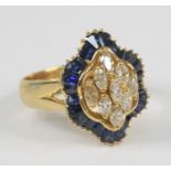 An 18ct yellow gold, sapphire and diamond navette style cluster ring, featuring a centre section