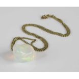 A polished opal pendant, of irregular slab-sided form, estimated weight approx 23 carats, w.20mm,