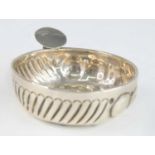 A 19th century French silver tastevin, the circular bowl having wavy decoration to one side and
