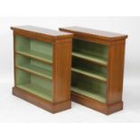 A pair of walnut and figured walnut freestanding open bookcases, each in the Georgian style,