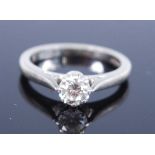 A platinum diamond solitaire ring, comprising a round brilliant cut diamond in an eight claw