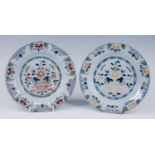 A pair of English polychrome delftware plates, probably Lambeth, circa 1740, each decorated with a