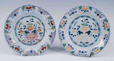 A pair of English polychrome delftware plates, probably Lambeth, circa 1740, each decorated with a