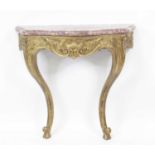 A continental giltwood and gesso marble topped console table, having shell and acanthus leaf swept