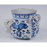 An English blue and white delftware posset pot, probably London, circa 1700, the serpentine spout