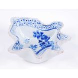A Delft blue and white pickle dish, 18th or 19th century, of leaf form, decorated with a bridge
