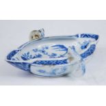 A Liverpool style blue and white double ended sauce boat, 18th century style, flanked by twin fox